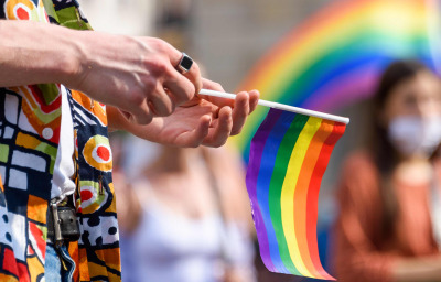 hand hold LGBT paper flag