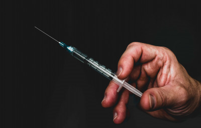 Doctor holding an injection with a needle
