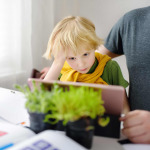 Father helping son with disability studying homework