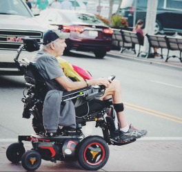Man crossing road in power wheelchair