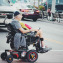 Man crossing road in power wheelchair