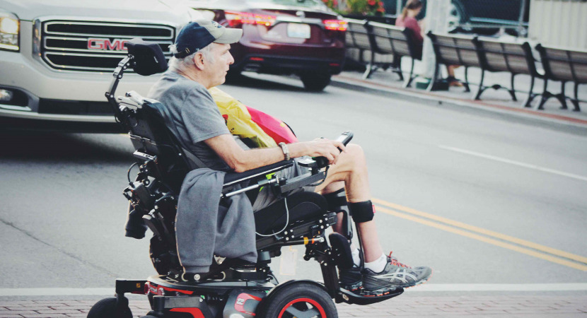 Man crossing road in power wheelchair