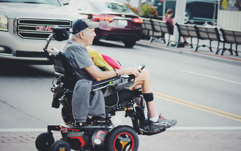 Man crossing road in power wheelchair