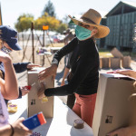 Women wearing mask and packing food