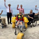 (L-R) Lachy Chapman, Spinal Life Australia, Mayor Mark Jamieson, Compass CEO David Dangerfield, Compass trainee Cole Kienzle (front, in beach wheelchair), Katie Hammond, Spinal Life Australia and Division 2 Councillor Terry Landsberg.