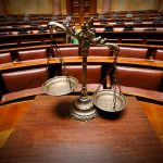 Symbol of law and justice in the empty courtroom, law and justice concept.