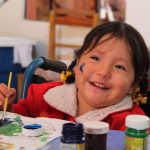 Kid with disability drawing