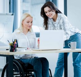 Front view of woman in wheelchair working at desk