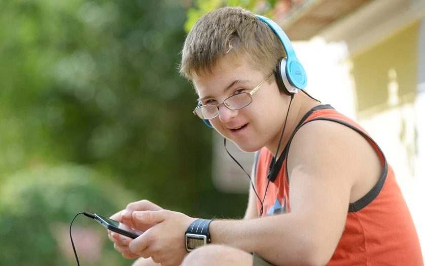 Teenager with Down syndrome enjoying technology