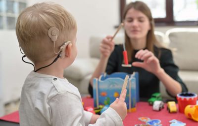 A Boy With A Hearing Aids And Cochlear Implants Playing