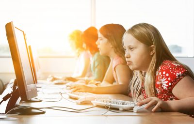 Girl with Down syndrome using computer