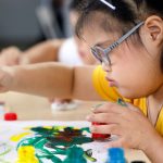 Girl with Down syndrome painting.
