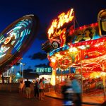 The glowing lights draw folks to the Boardwalk amusement park in Seaside Heights, New Jersey