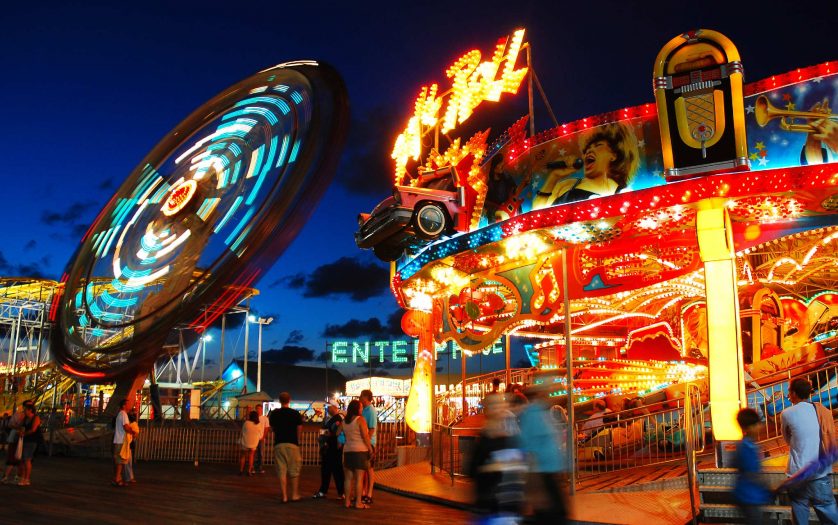 The glowing lights draw folks to the Boardwalk amusement park in Seaside Heights, New Jersey