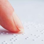 Blind people reading Braille.