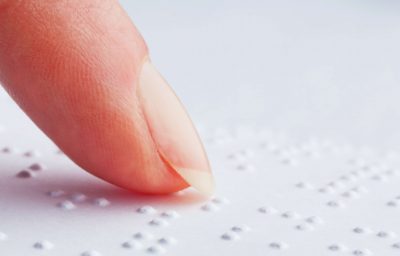 Blind people reading Braille.