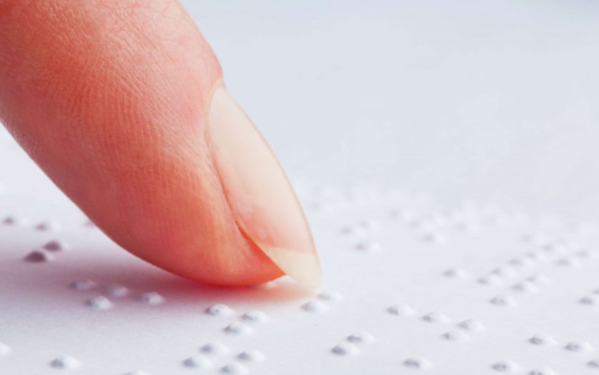 Blind people reading Braille.