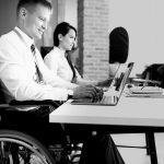 Businessman in a wheelchair working at a laptop