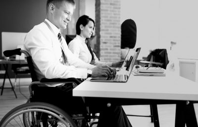 Businessman in a wheelchair working at a laptop