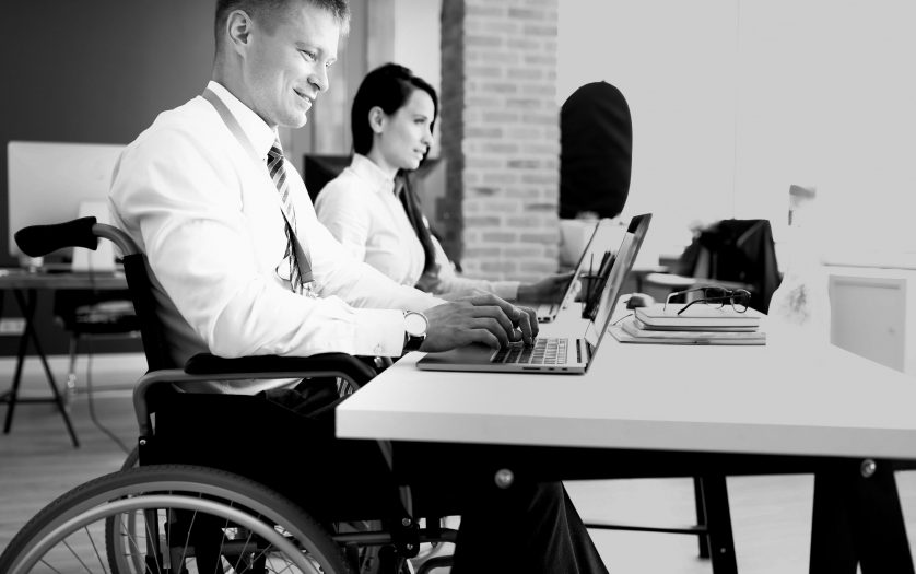 Businessman in a wheelchair working at a laptop