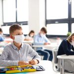 children with face mask back at school after covid-19 quarantine and lockdown.