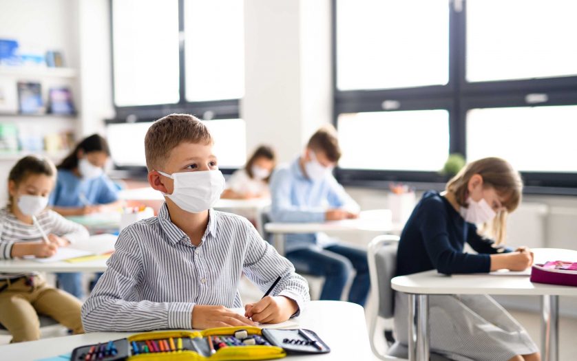 children with face mask back at school after covid-19 quarantine and lockdown.