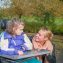 A disabled child in a wheelchair being cared for by a care worker