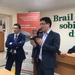 SEZUAL partner Dastan Sagynali (R) while demonstrating Sezual’s Braille self-tutoring device at School