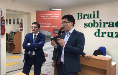 SEZUAL partner Dastan Sagynali (R) while demonstrating Sezual’s Braille self-tutoring device at School