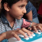a blind boy learning braille