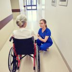 nurse with woman in wheelchair at hospital