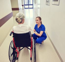 nurse with woman in wheelchair at hospital