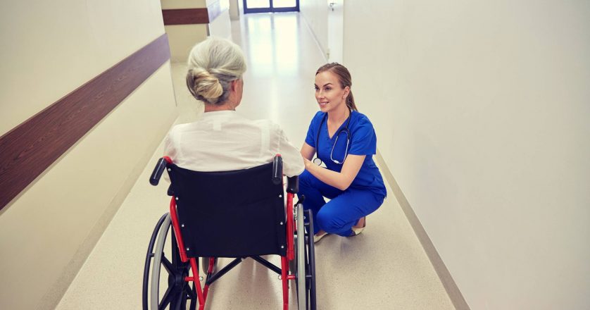 nurse with woman in wheelchair at hospital