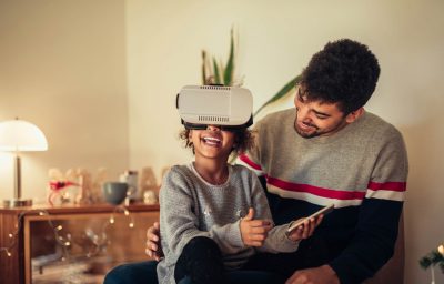 Cute young african american girl using a VR headset.