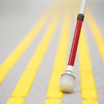 Blind pedestrian walking and detecting markings on tactile paving with textured ground surface indicators