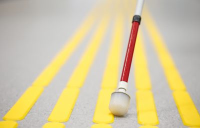 Blind pedestrian walking and detecting markings on tactile paving with textured ground surface indicators