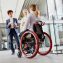 woman in wheelchair talking with colleageues during a break