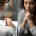 Young depressed women talking to lady psychologist during session, mental health