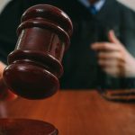 Male judge in a courtroom with the gavel