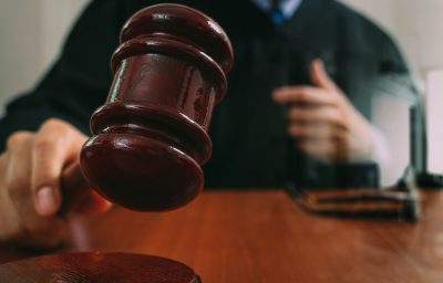 Male judge in a courtroom with the gavel