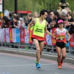 female vision impaired runner Misato Michishita running on the street with a male guide