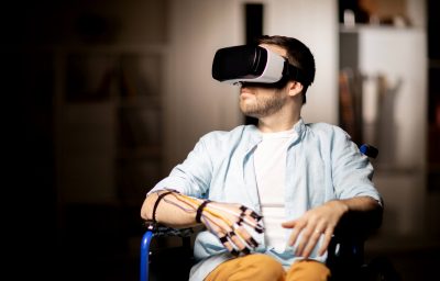 man in wheelchair traveling in virtual reality while spending time at home