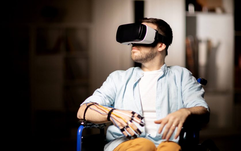 man in wheelchair traveling in virtual reality while spending time at home