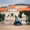 man tourist in wheelchair traveling in Europe. Lower Belvedere at background, Vienna, Austria