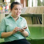 young blind woman using smartphone