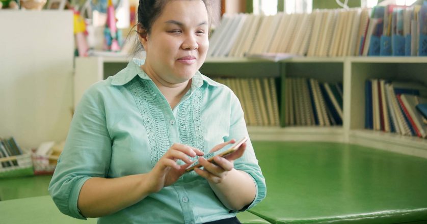 young blind woman using smartphone