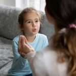 deaf girl talking in SL with female tutor at home