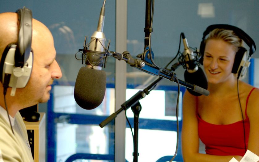 white male and female radio presenters in local radio station