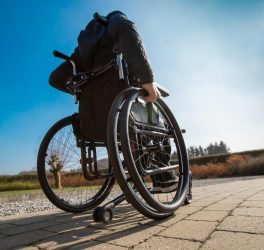 Disabled man in wheelchair outdoor in the sun