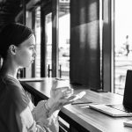 Side view of woman using sign language during video call